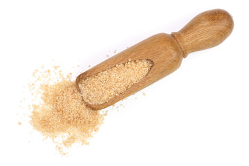 brown sugar in wooden scoop isolated on white background. Top view. Flat lay