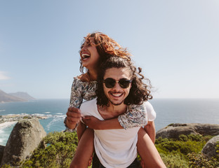 Man giving piggyback ride to his girlfriend