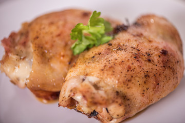 roasted chicken tights on white plate 