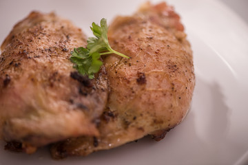 roasted chicken tights on white plate 