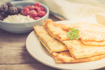 fresh pancakes with fragrant maple syrup and honey. Russian holiday pancake week. crepes with honey or syrup