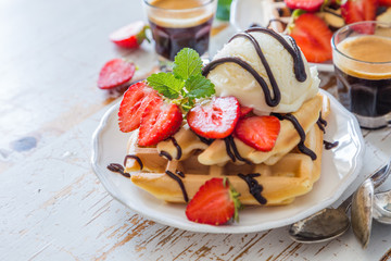 Waffles with strawberry, ice cream and chocolate