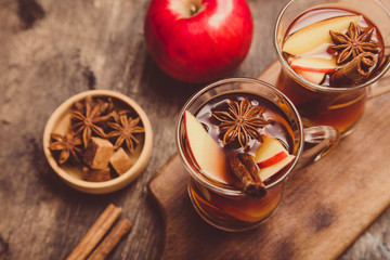hot spicy beverage. Hot drink (apple tea, punch) with cinnamon stick and star anise. Seasonal mulled drink
