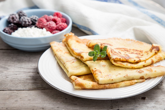 fresh pancakes with fragrant maple syrup and honey. Russian holiday pancake week. crepes with honey or syrup