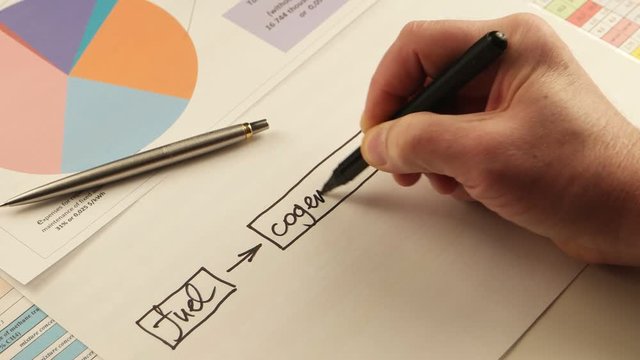Businessman draws  flowchart on the background of documents