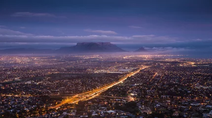 Tuinposter City scape over Cape Town South Africa at dawn, as seen from Tygerberg hill in the Northern Suburbs of Cape Town. © Dewald
