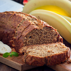 Sliced banana cake with whole-grain flour on a wooden board, selective focus