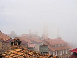 rooftops and ancient architecture in georgian village at misty day, Signagi, Georgia