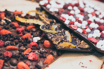 three types of craft homemade chocolate with fruits and berries with selective focus