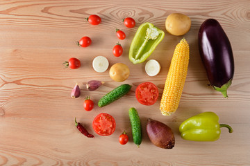 Vegetables laid out on a wooden table. Flat lay,top view. Free space for text.