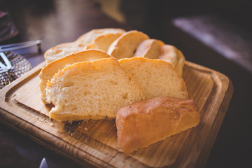Close up image sliced bread served on a wooden chopping board