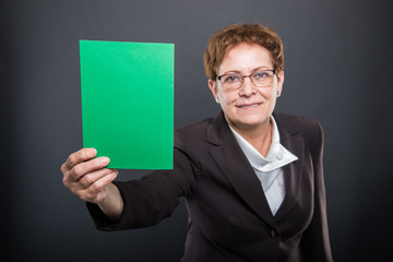 Selective focus of business senior lady holding green cardboard