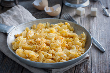 Pasta cooked with egg in a frying pan, rustic style, selective focus