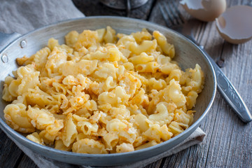 Pasta cooked with egg in a frying pan, rustic style, selective focus