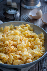 Pasta cooked with egg in a frying pan, rustic style, selective focus