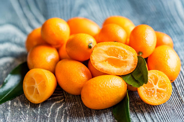 Kumquat or cumquat on wooden table