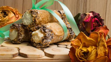 cannoli sweets with rose decoration
