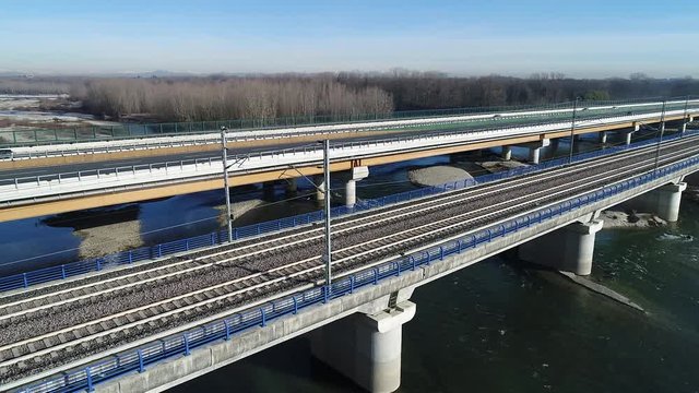 Motorway and railway bridge on the Ticino river in the Po Valley, Italy.