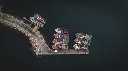 Aerial views over Gansbaai harbor in the overberg in the Western Cape of South Africa With fishing vessels laying at anchor in the harbor
