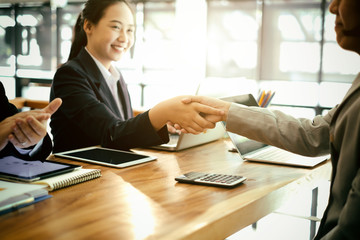 success business partners shaking hands after complete a deal in office, success deal and strategy concept
