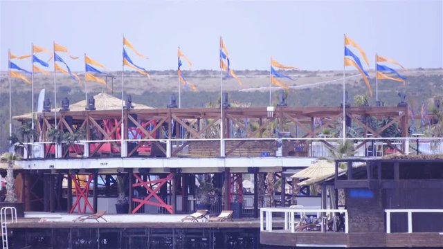 Beach house with many flags 4K