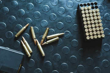 top view of rifle bullets and magazine on table