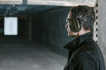 side view of handsome man looking at target in shooting range © LIGHTFIELD STUDIOS