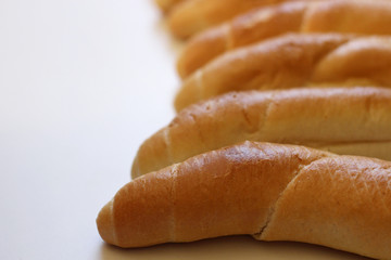 Delicious freshly baked rolls on a wood background the highest quality. Ideal shape and color blush removed from the oven. Blurred background.