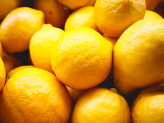Fruit concept. Many oranges are in a rattan basket for sale in supermarket. Blurred background and copy space.