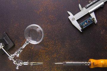 A Arduino Nano board in calipers measuring. Equipment for inventions and developments, Magnifier...