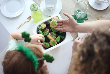 Woman and child tasting cookies at kitchen