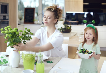 Mother with child make preparations for .Saint Patrick's Day.