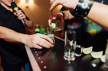 preparing green mexican cocktail drink at the bar