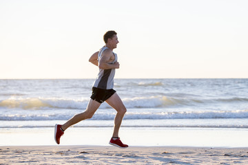 athletic fit and strong runner man training on Summer sunset beach in sea shore running and fitness workout in sport and healthy lifestyle