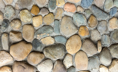 stone pattern round cobblestone middle background part of the wall of the base