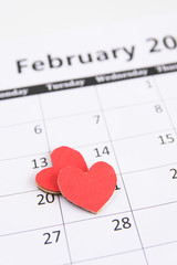 Fototapeta na wymiar Calendar page and red hearts paper on February 14 of Valentines day.