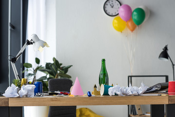 party decorations, bottle of champagne and balloons in office