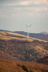 Wind turbines in the mountain, at a sunny autumn day