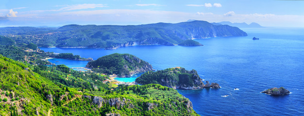 Beautiful summer panoramic seascape. View of the coastline into the sea bay with crystal clear azure water. Paleokastrica. Corfu. Ionian archipelago. Greece. - obrazy, fototapety, plakaty