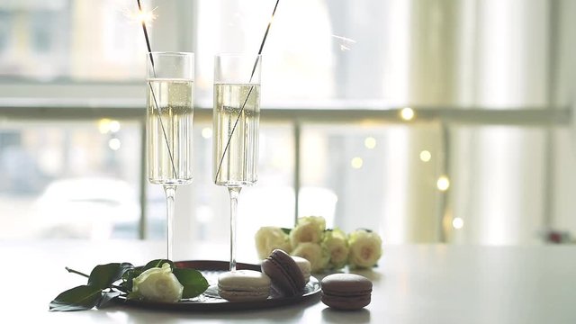 Luxurious champagne wedding party with white roses and macaron desserts, holiday celebration with wine