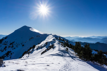Fototapeta na wymiar Summit of Dourdouvana snow covered mountain in Peloponnese Greece