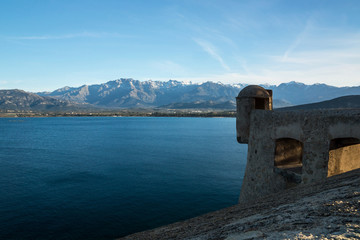 Fototapeta na wymiar Corsican sea view from Calvi citadel on snowy mountains.