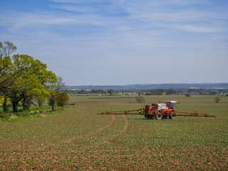 Fototapeta premium tractor crop spraying a field