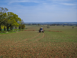 tractor crop spraying a field