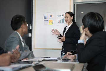 businesswoman present financial plan report to co worker team. woman leader  discuss sales data with investor colleagues. finance investment business meeting