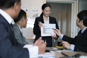 businesswoman present financial plan report to co worker team. woman leader  discuss sales data with investor colleagues. finance investment business meeting