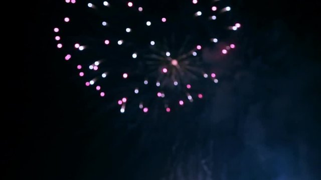Motion background of defocused fireworks at night with colored bokeh sparkles