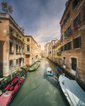 Venecia canal with boats and gondolas, Italy