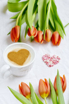 Cappuccino with Heart Pattern of Cinnamon and Flowers Composition Tulips White Background Valentines Day Spring Concept