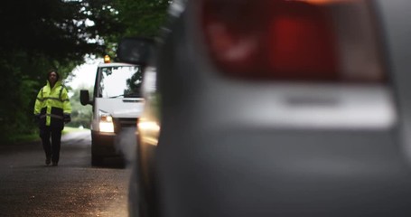 4K Female recovery driver arrives at scene of breakdown to help stranded motorist. Slow motion.